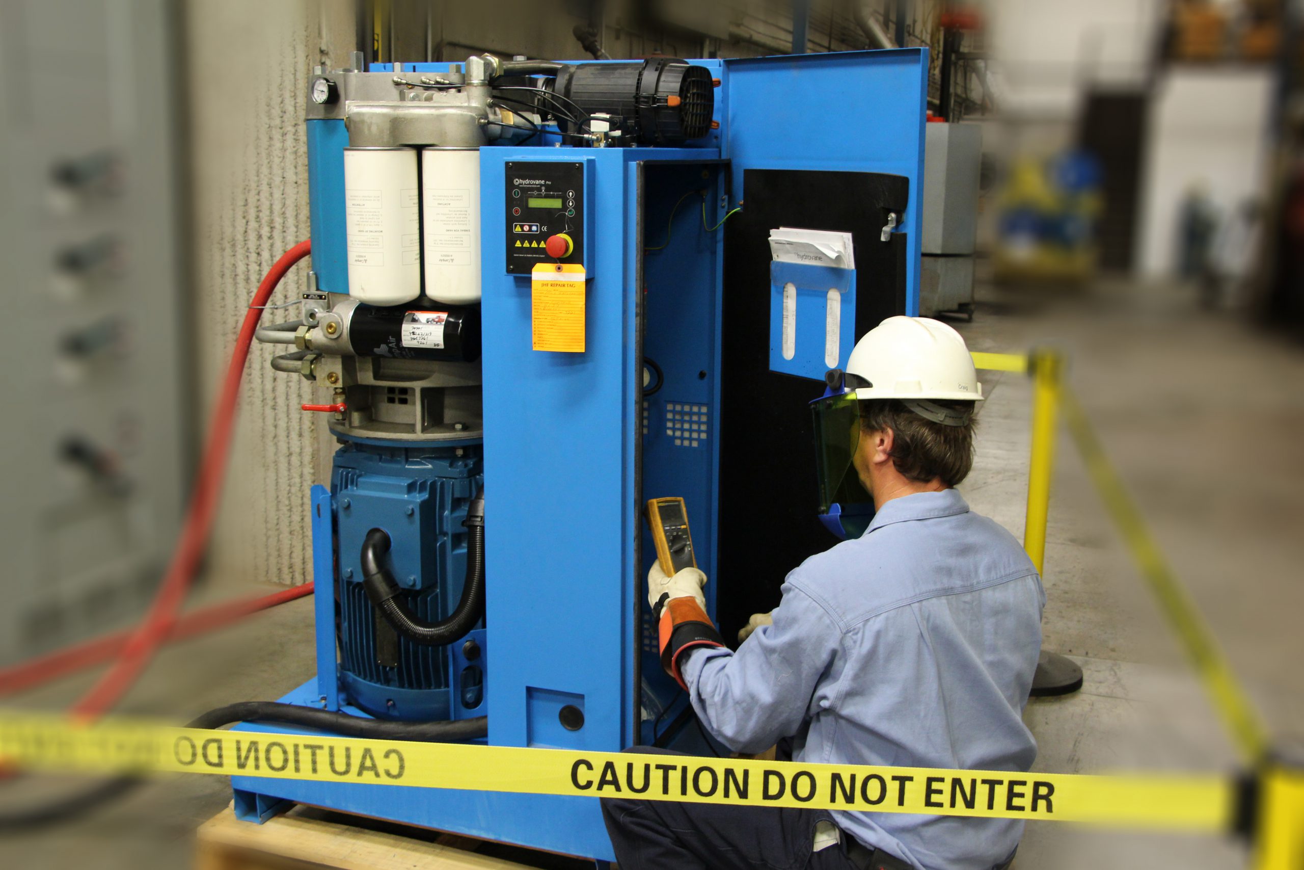 A technician analyzes the parts within an air compressor.