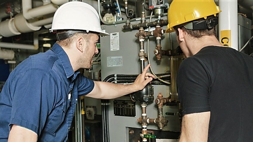 Repairmen working on compressed air system